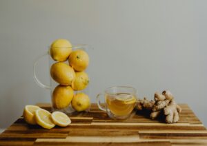Photo by Kelly Sikkema a wooden table topped with lemons and ginger